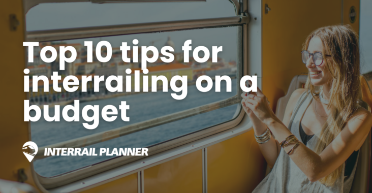 Woman looking out of train window - The top 10 tips for interrailing on a budget